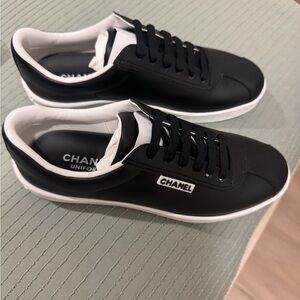 CHANEL Black and White Low-Top Leather Sneakers with Logo Patch